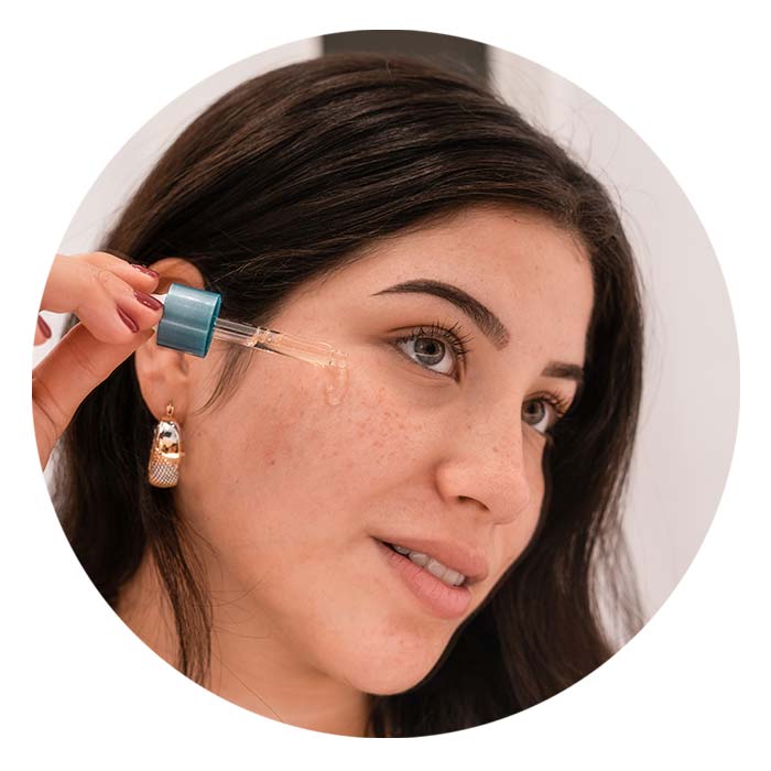 Woman applying CBD Skincare on her face
