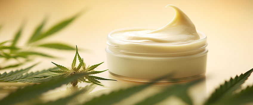 yellow cbd cream next to leafs