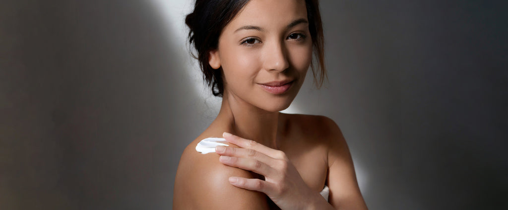 femme s'étalant de la crème cbd sur l'épaule