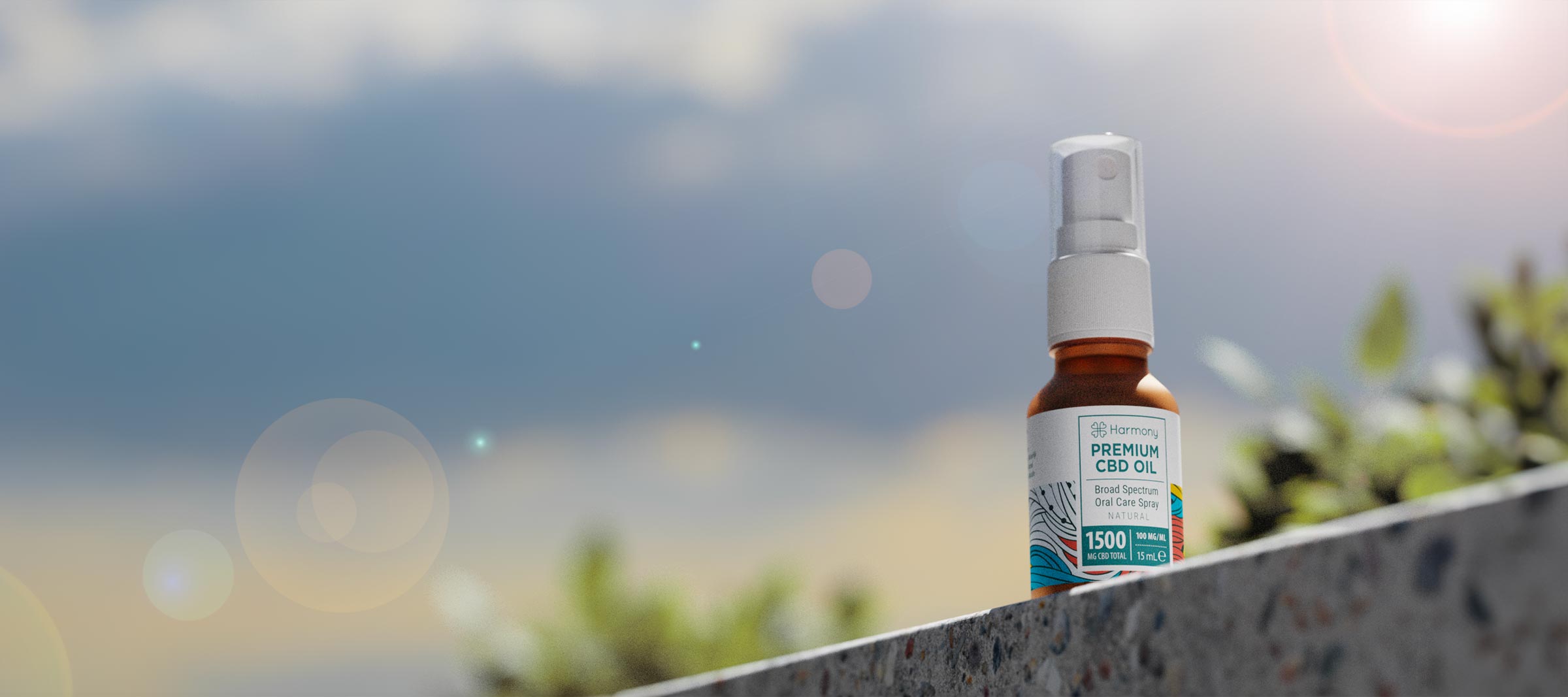 Harmony CBD spray in sunlight with mountains in the background