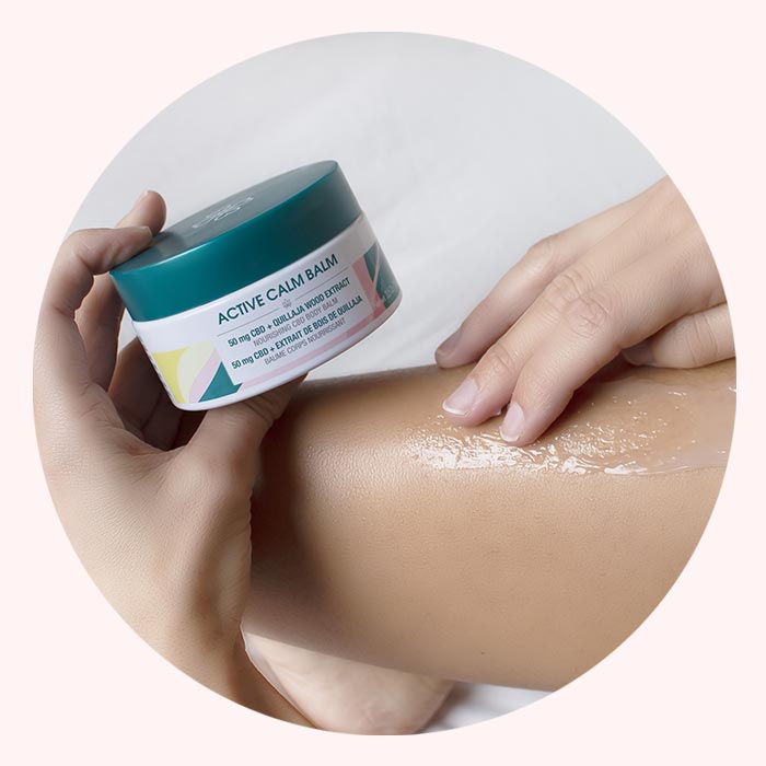 Woman applying active calm balm CBD skincare